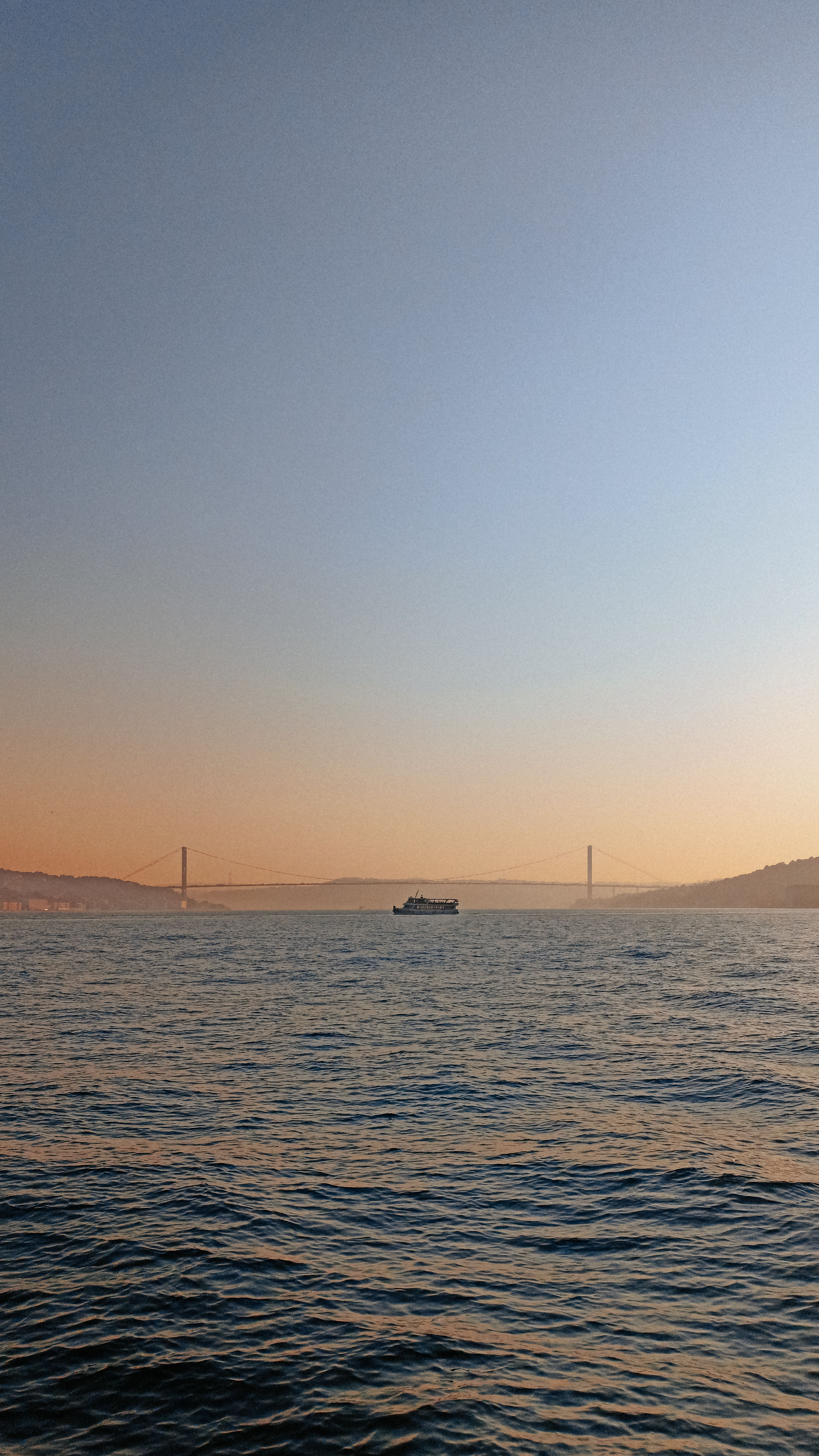 A Boat on a Body of Water Under Blue Skies During Sunset · Free Stock Photo