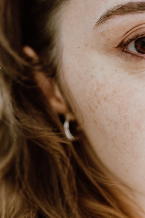 Woman With Brown Hair Wearing Silver Hoop Earrings