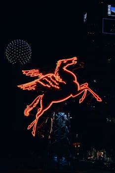 A striking neon Pegasus sign illuminated at night, capturing urban vibrant night life.