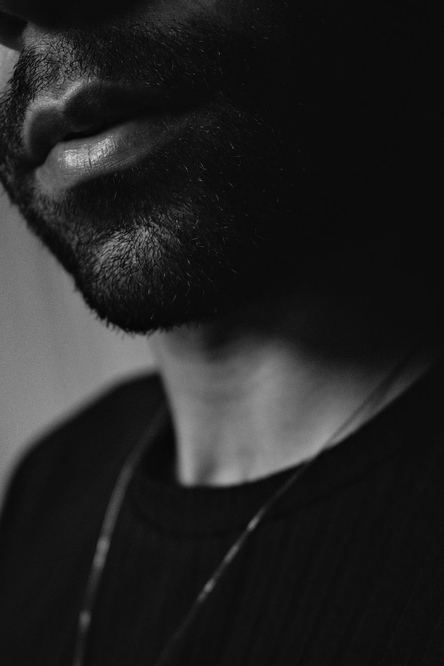 Artistic grayscale portrait with focus on facial hair and lips.