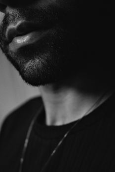 Artistic grayscale portrait with focus on facial hair and lips.