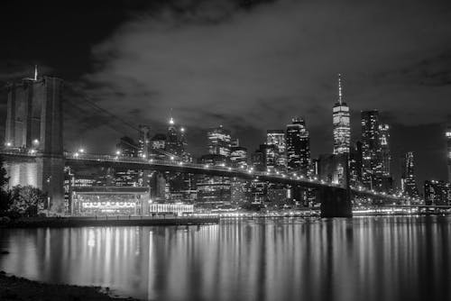 Grayscale photo of the Brooklyn Bridge and the Manhattan Skyline