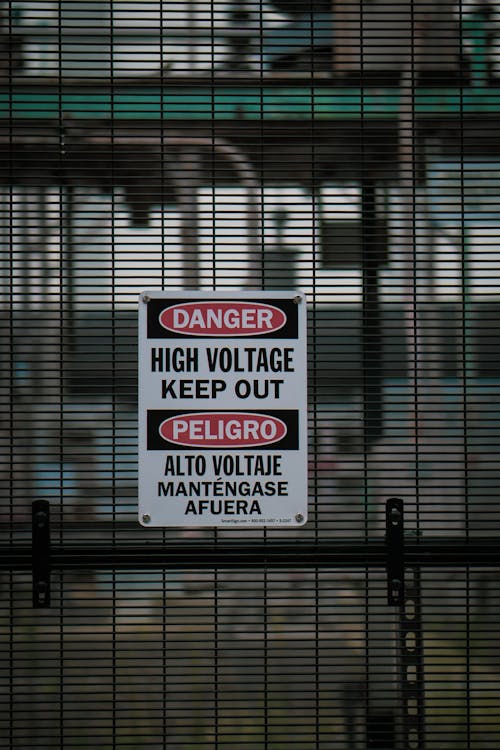 Free Warning Sign in English and Spanish Stock Photo