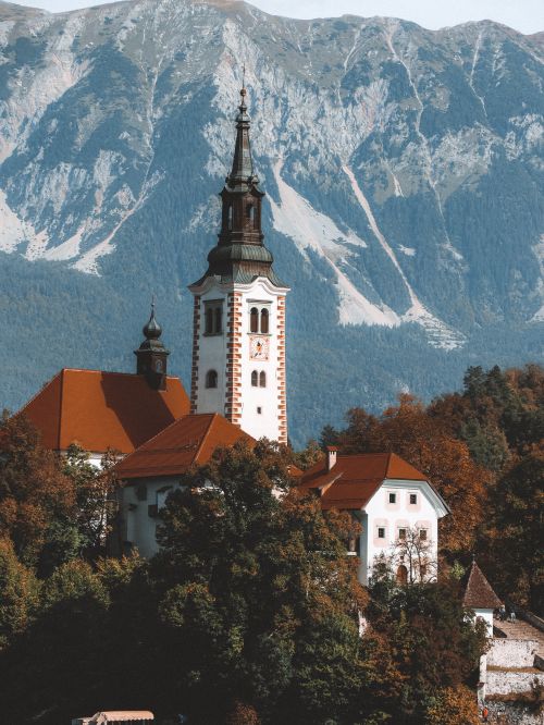 Free A stunning view of the historical Bled Church set against the majestic Julian Alps in Slovenia. Stock Photo