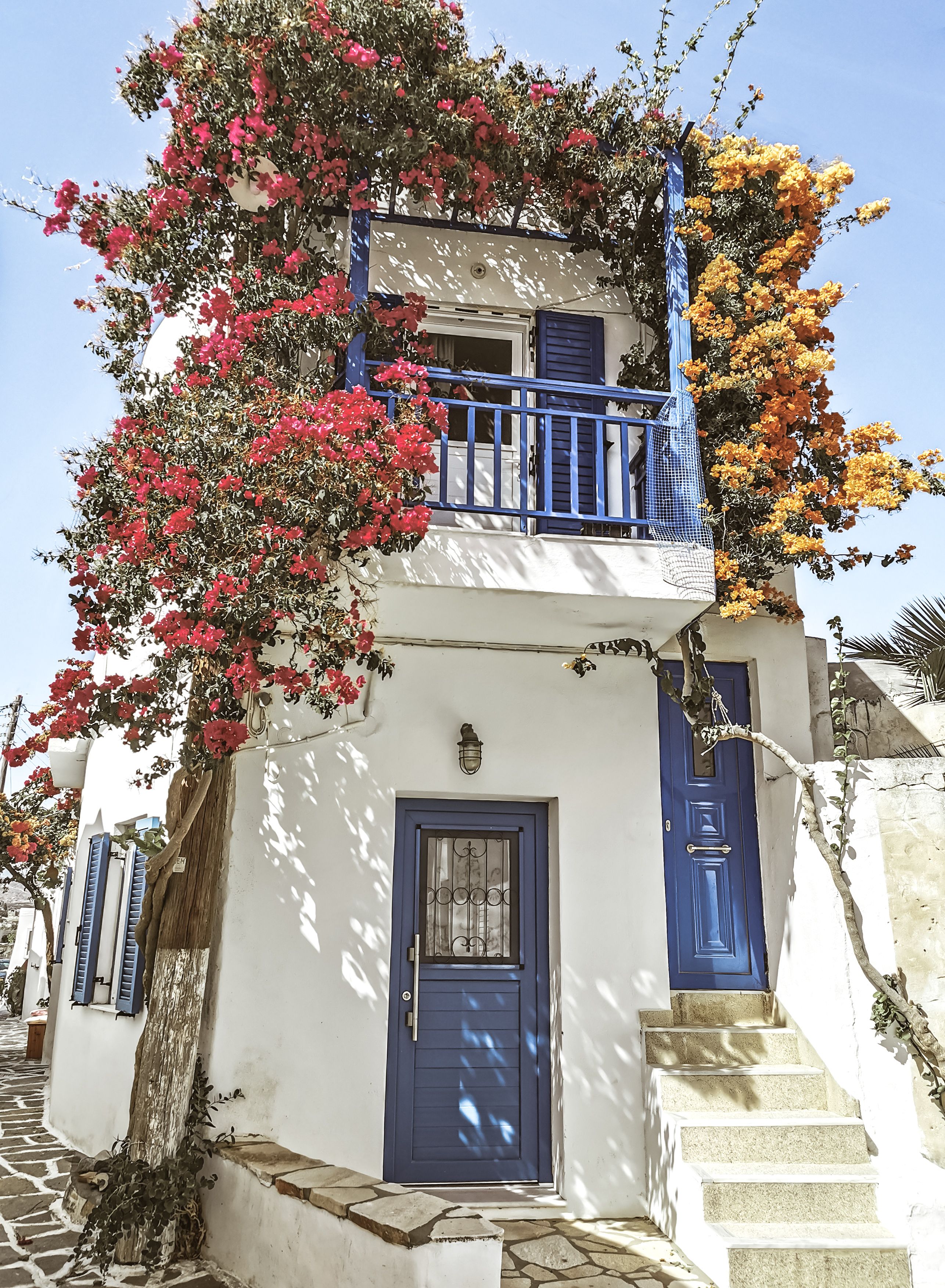 White Painted House With Blue and Teal Terrace · Free Stock Photo