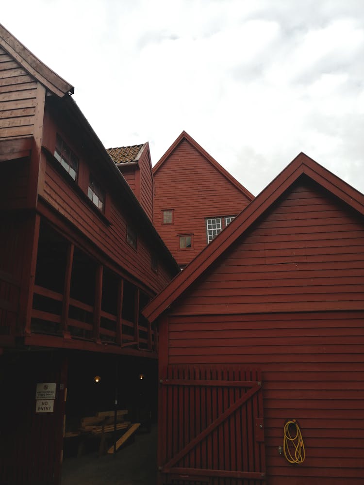 Brown Wooden Building Under Cloudy Sky