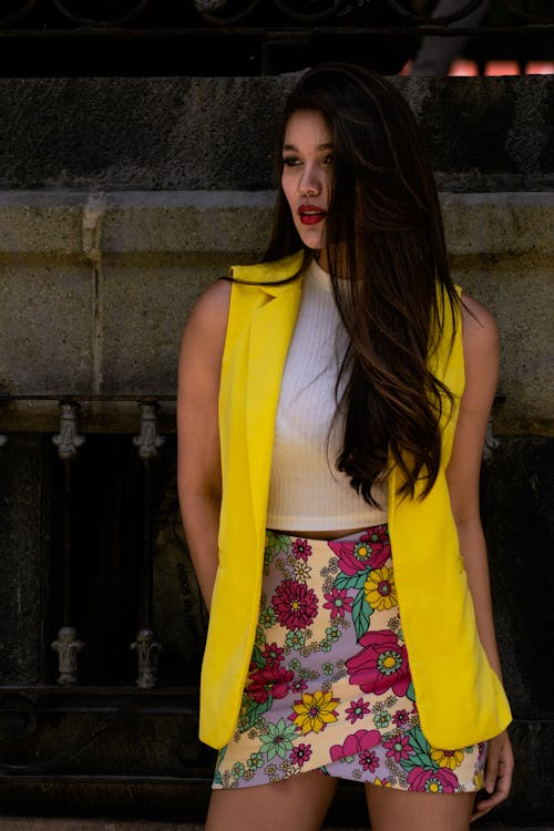 A Woman in Yellow Sleeveless Shirt and Pink Floral Skirt 