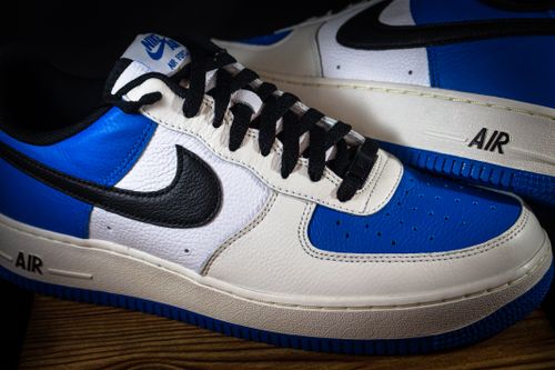 Free Detailed close-up of stylish blue and white sneakers, ideal for fashion lovers. Stock Photo