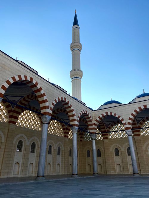 Free Stunning view of Camlica Mosque's minaret with arches against a clear blue sky. Stock Photo