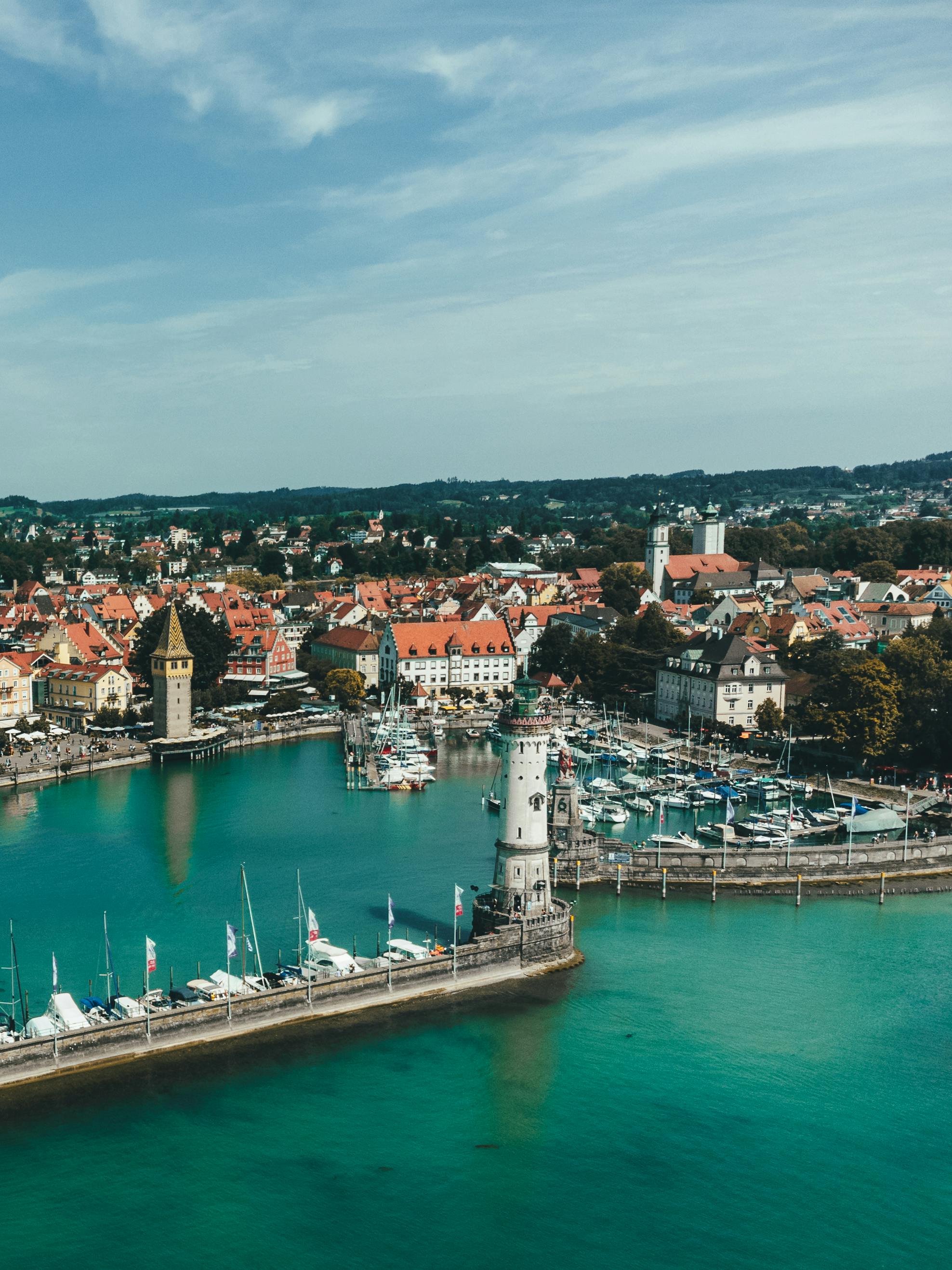 Breathtaking aerial view of Lindau Harbor with lighthouse and marina on Lake Constance, Germany.