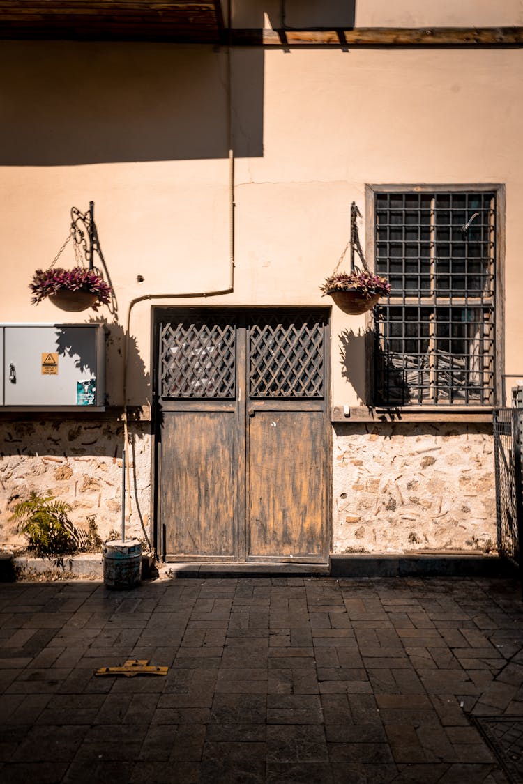 Building Wooden Doors And Flowers At Entrance