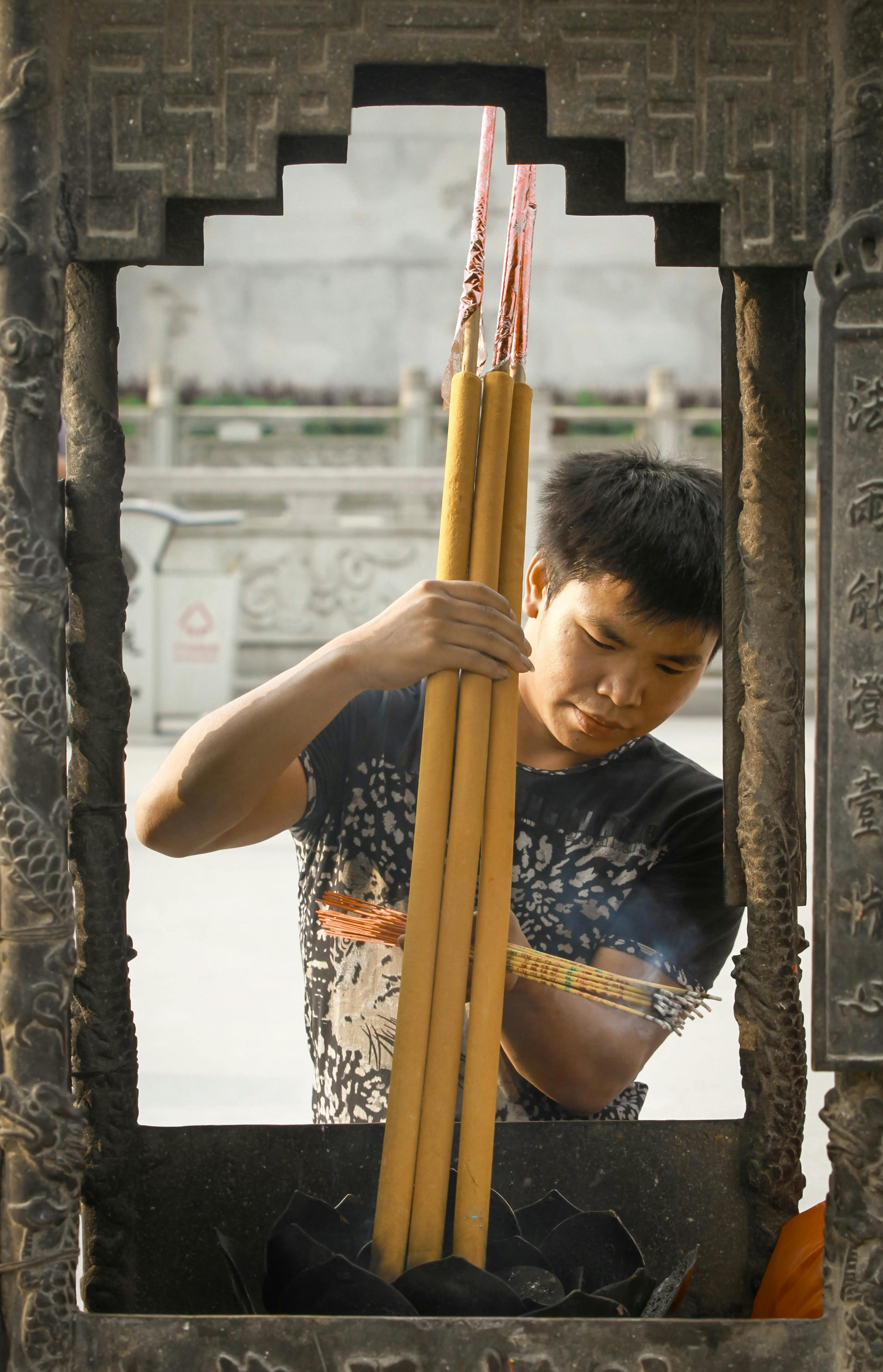 Man Burning Big Incense Sticks · Free Stock Photo