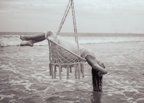Black and White Photo of Woman on a Hammock