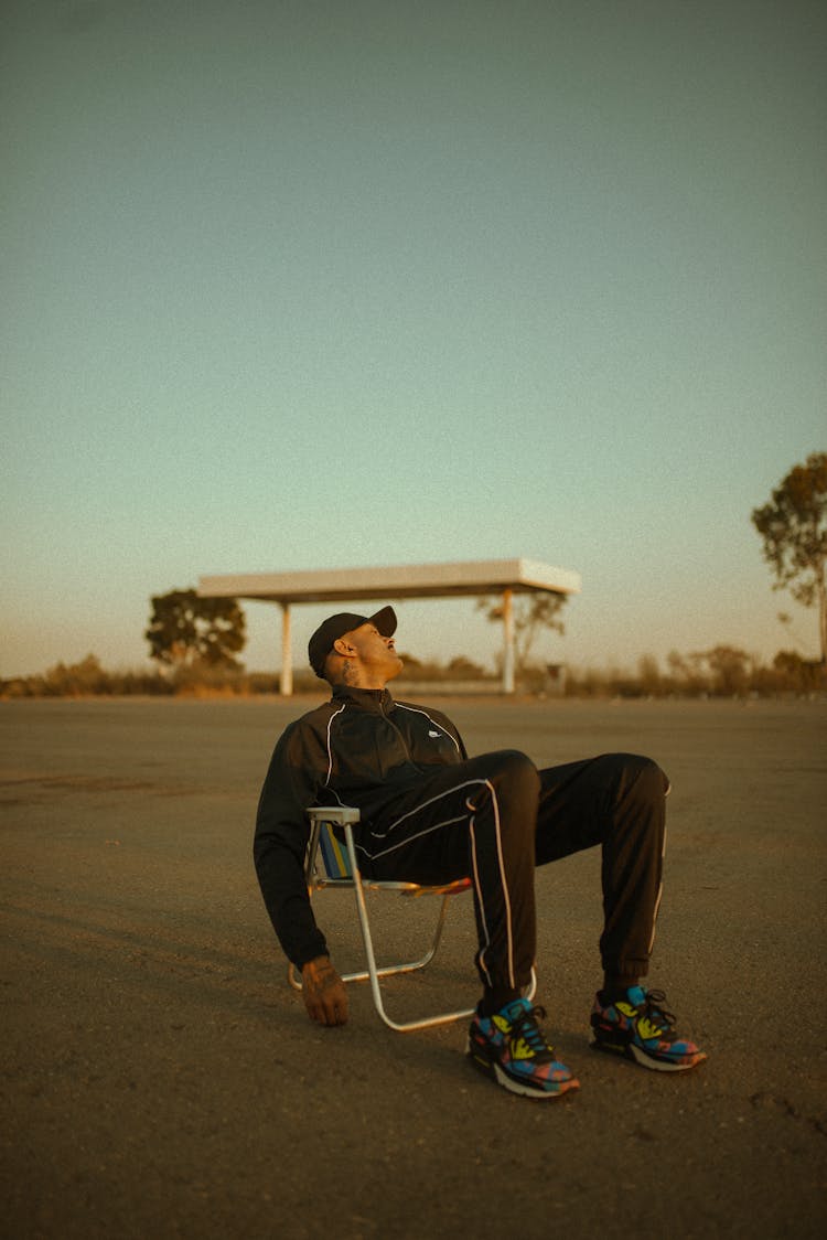 Man In Sports Clothing On Chair