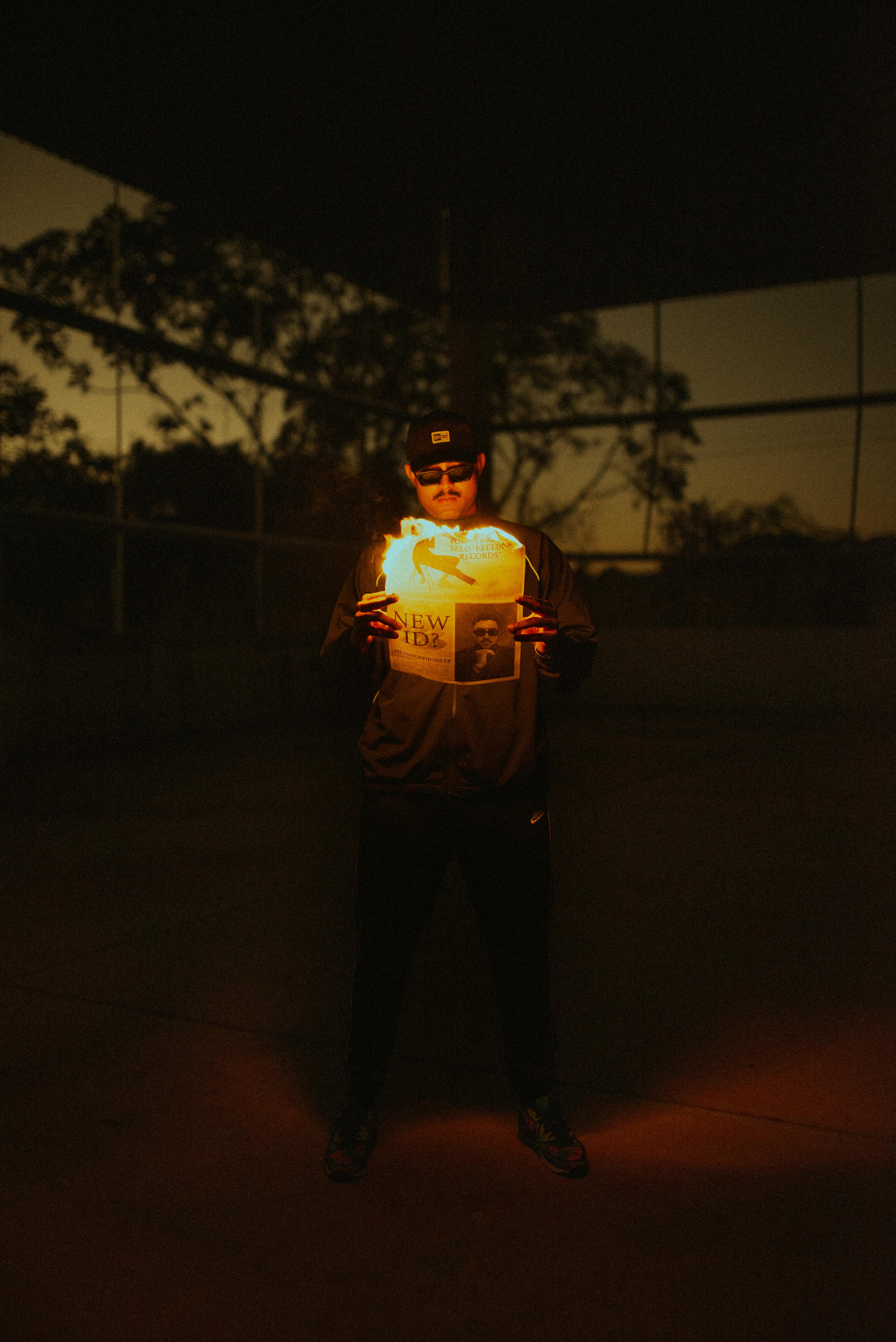 man with burning newspaper