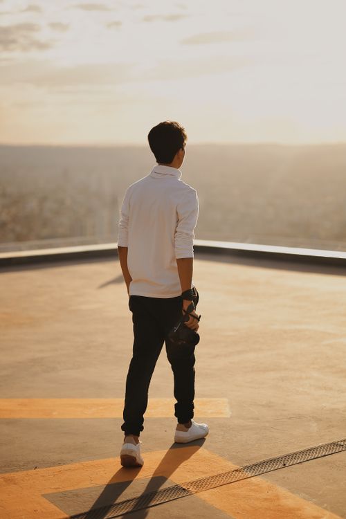 Man on a Roof During Sunset · Free Stock Photo