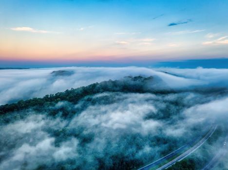 Stunning aerial shot of clouds over a forested landscape at sunrise in Weaver, MN.