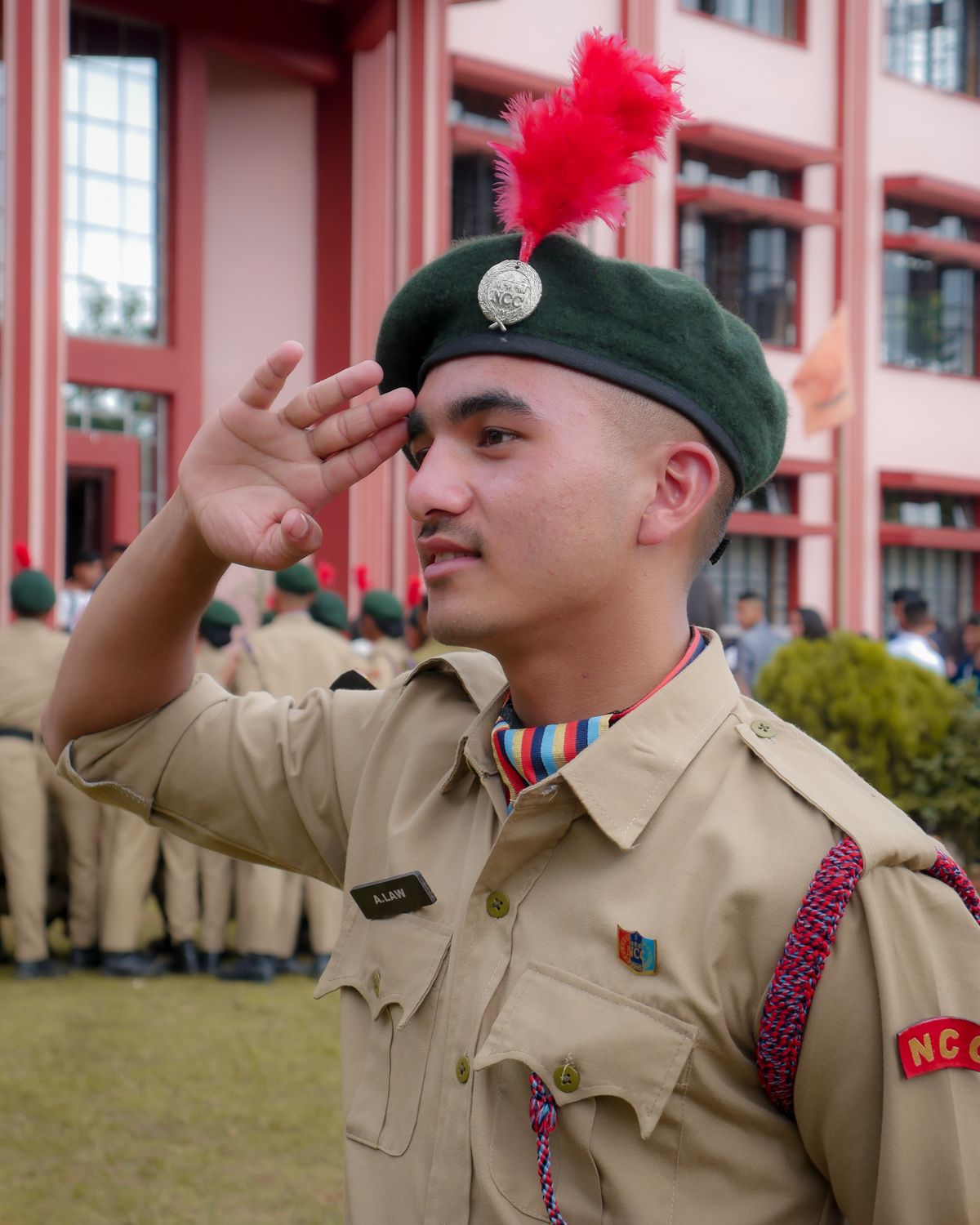 A young soldier in uniform saluting outdoors, illustrative of Sainik School training