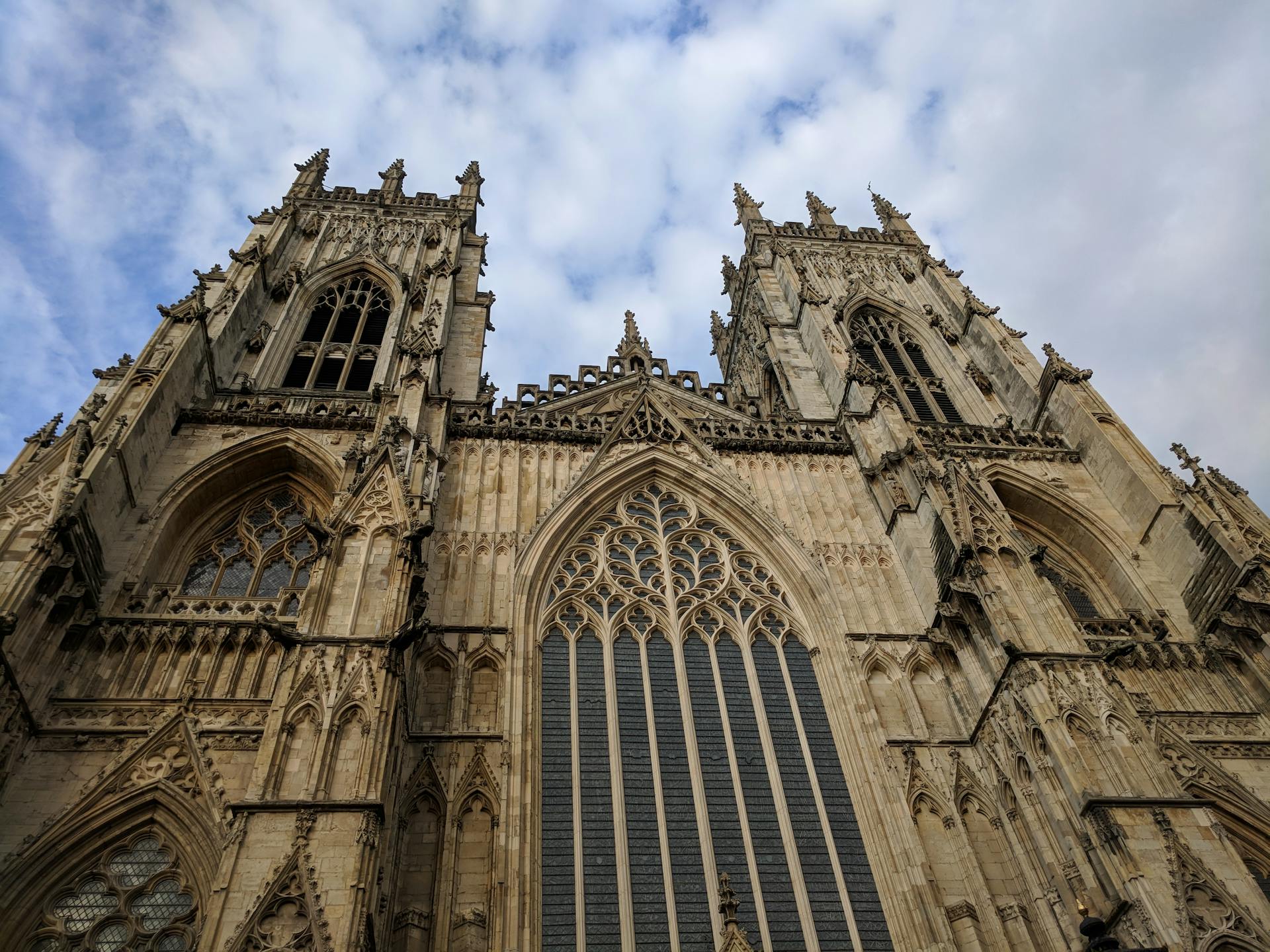 A captivating low angle shot of the historic York Minster with a dramatic sky backdrop.