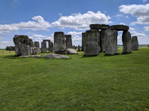 Free Explore the ancient Stonehenge monument on a sunny day with scattered white clouds. Stock Photo