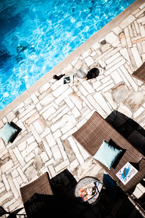 High Angle Shot of Poolside Beds