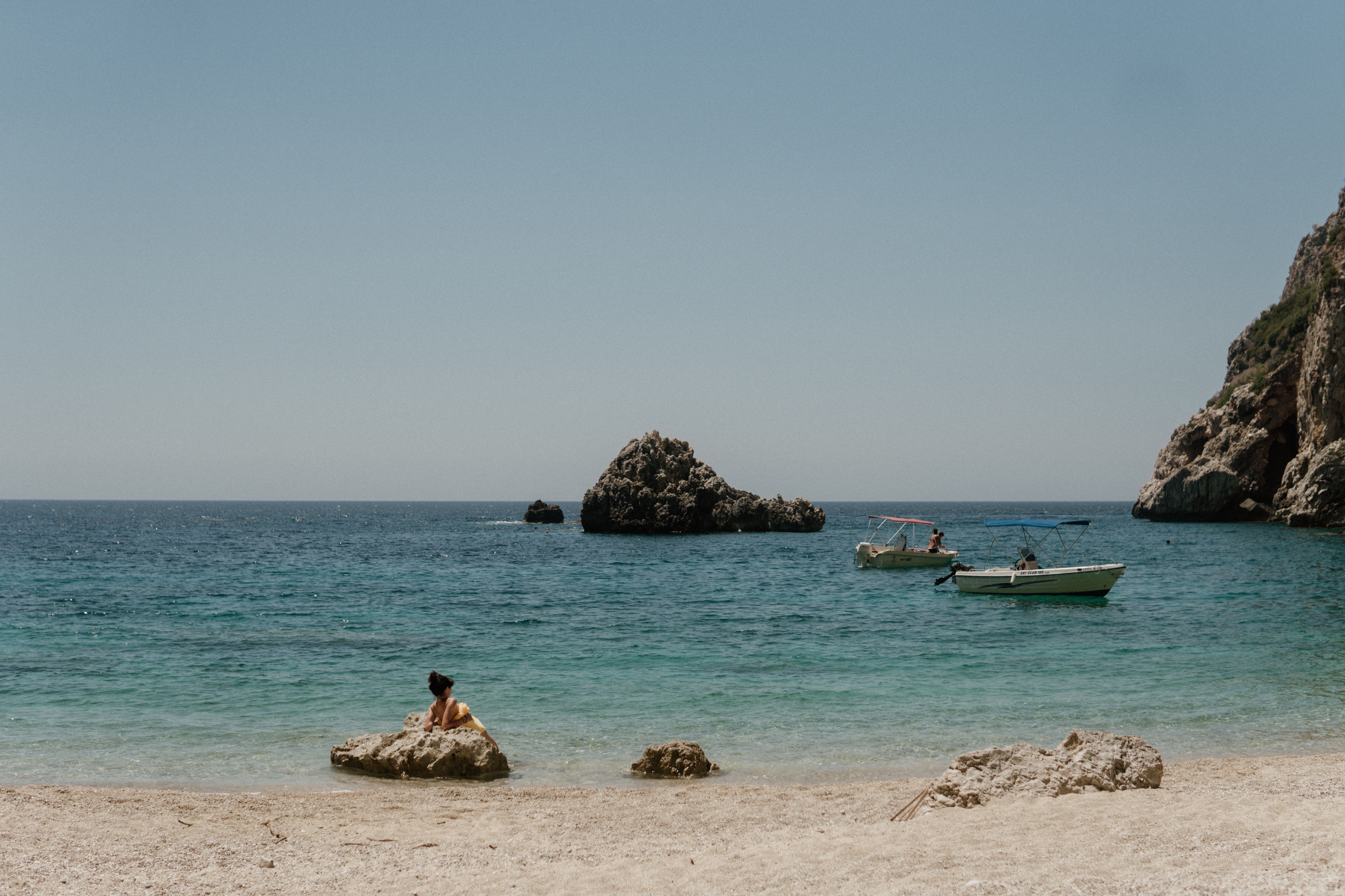 A Wooden Boat Sailing on the Sea Under Blue Sky · Free Stock Photo