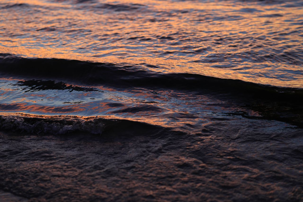 close up of waves during sunset highlighting the sea s vibrant colors