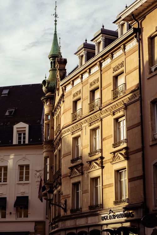 Free Capture of a historic European building with Gothic architecture elements at sunset. Stock Photo