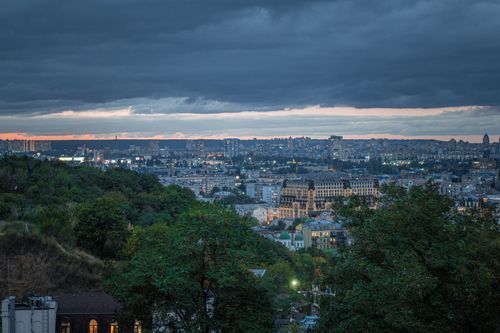 Free Captivating cityscape view with dark clouds at twilight showcasing a bustling urban landscape. Stock Photo