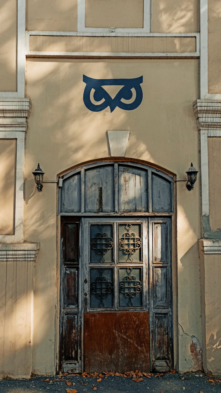 Doorway Of An Old Building With Painted Logo On The Wall