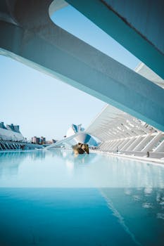 Stunning modern architectural design of Valencia's City of Arts and Sciences reflecting in calm water.