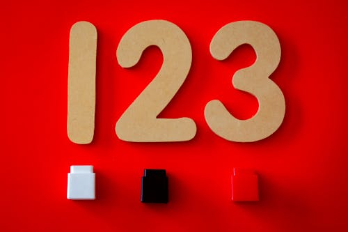 Free 123 Cutout Decor on Red Surface Stock Photo