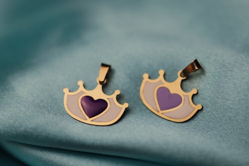 Free Crown Pendants on a Gray Fabric Stock Photo