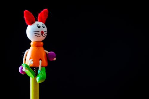 Free Vibrant close-up of a toy rabbit with bold colors against a black background. Stock Photo