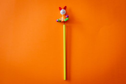 Yellow and Multicolored Animal Toy on Orange Surface