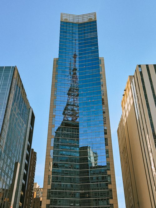 Free Modern glass skyscraper with reflection amidst blue skies in São Paulo, Brazil. Stock Photo