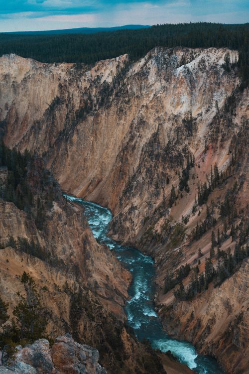 Free Aerial view captures the rugged beauty of the Grand Canyon of the Yellowstone with a winding river. Stock Photo