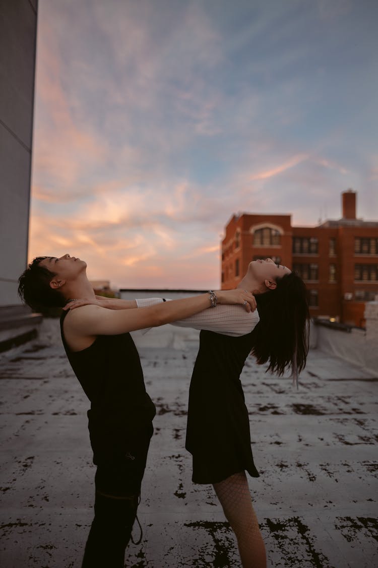 A Man And A Woman Standing Face To Face While Looking At The Beautiful Sky