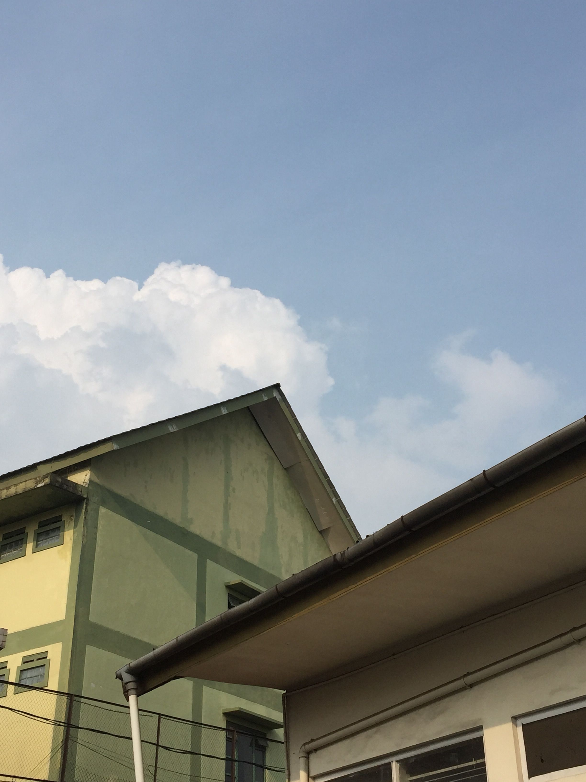 Low Angle Shot of Concrete Houses Under Blue Sky · Free Stock Photo