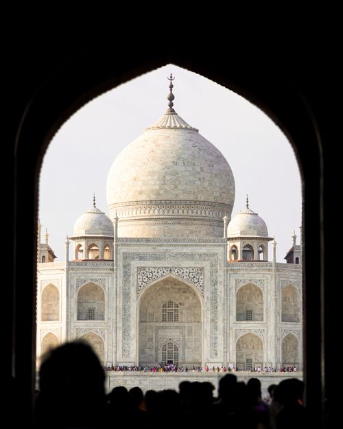 Free A stunning view of the Taj Mahal framed by an archway in Agra, India. Stock Photo