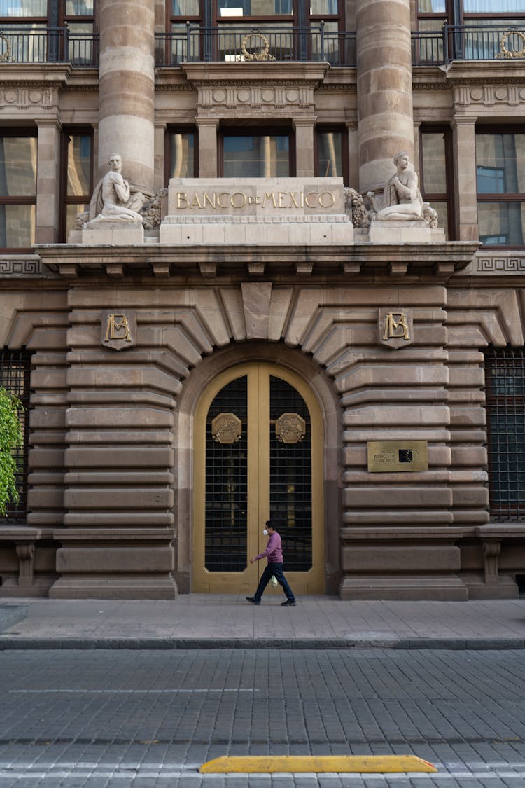 Man Walking In Front Of Bank Of Mexico