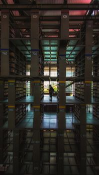 Mesmerizing silhouette of a man in a modern library in Mexico City. Dramatic lighting and architectural design.