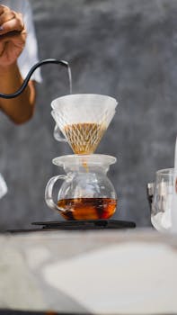 A detailed view of a pour over coffee being brewed with precision and care.