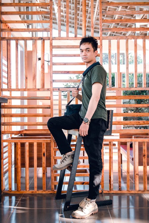 Free Man Standing Beside Chair Stock Photo