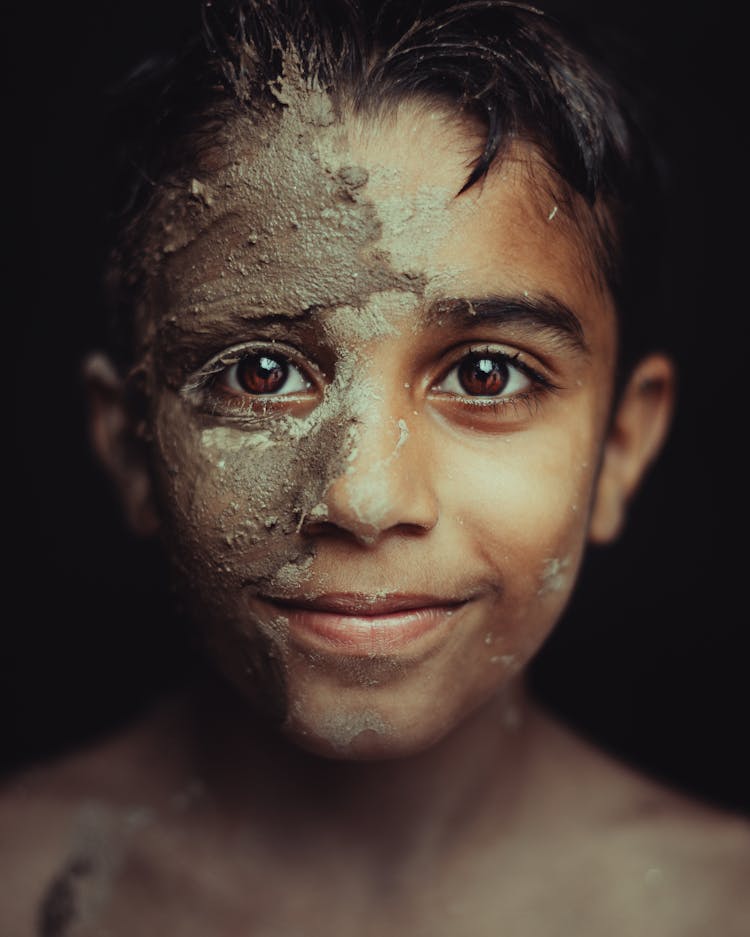 Portrait Of Boy In Mud