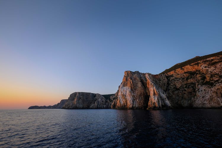 Scenic View Of A Cliff At Sunset 