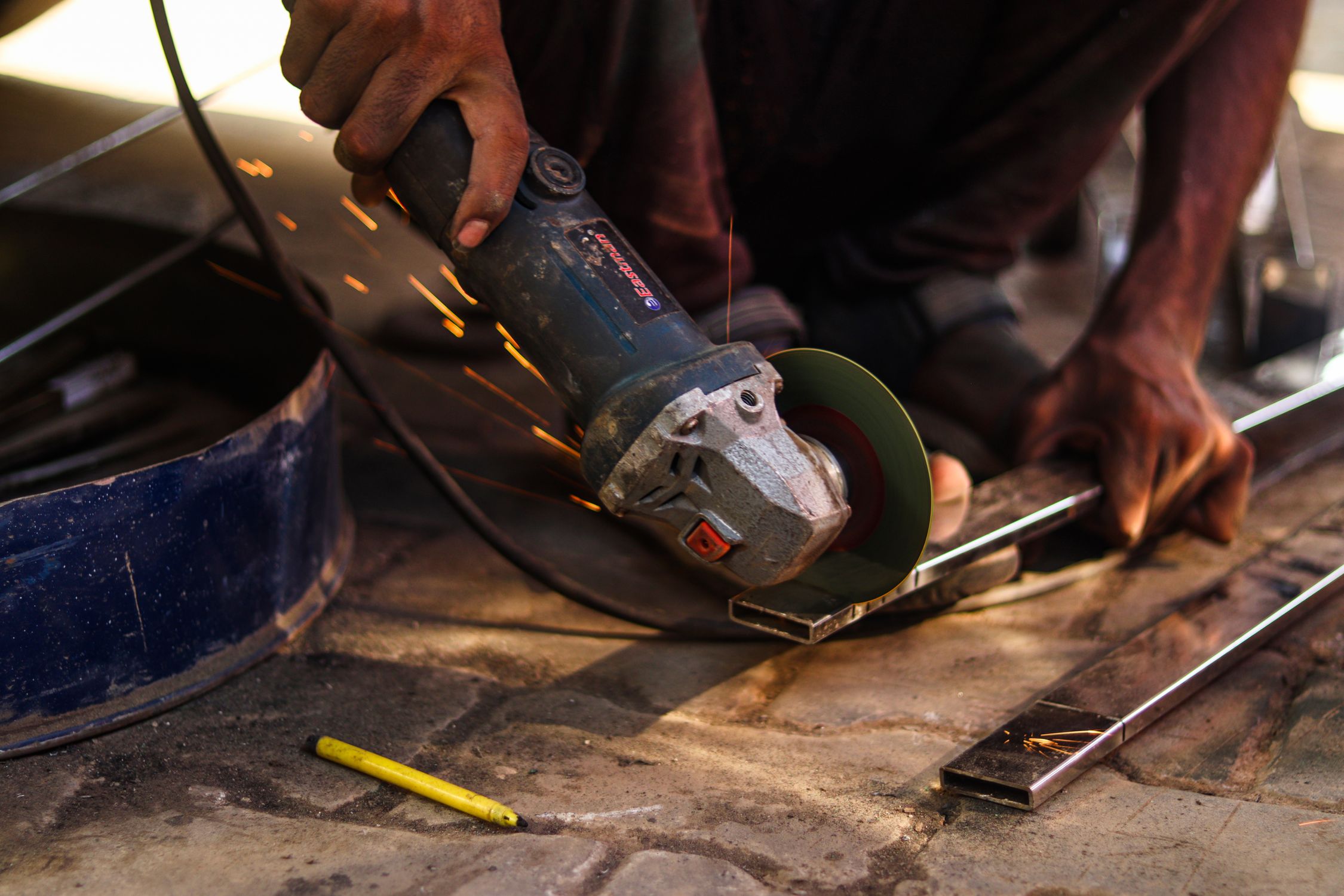 A Person Using an Angle Grinder · Free Stock Photo