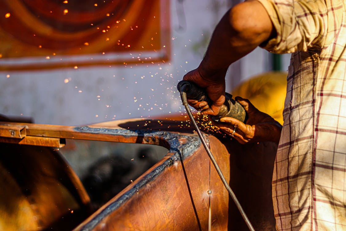 A Person Using Angle Grinder