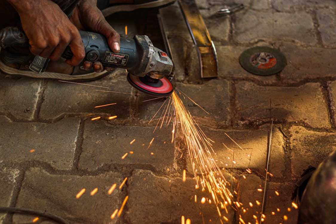 Person Using an Angle Grinder with Sparks