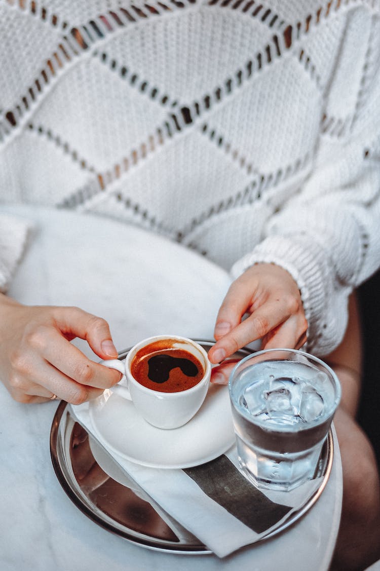 Close-up Of Woman Holding A Cup With Espresso 